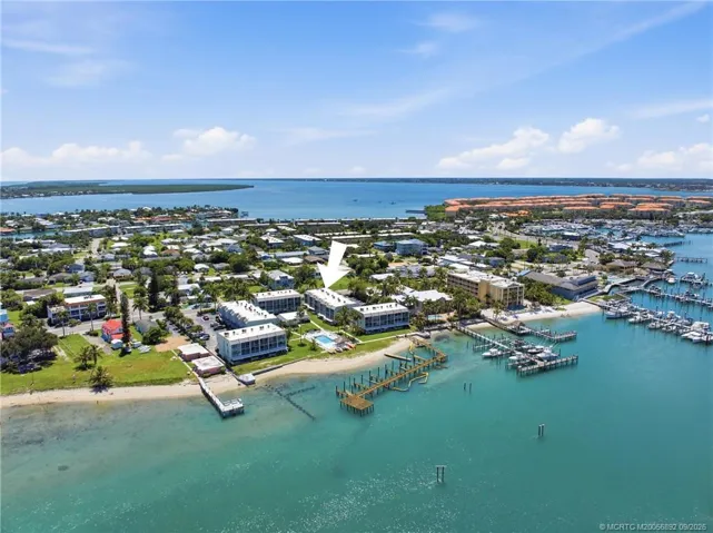 Aerial view with arrow identifying the building’s location along the waterfront, surrounded by marinas and coastal waterways.