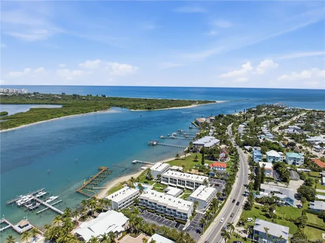 Wide aerial view highlights the inlet’s direct connection to the Atlantic Ocean and the surrounding natural shoreline.