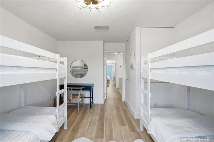 Reverse view highlights the bedroom’s flexible layout, storage, and space for a dedicated desk or work area.