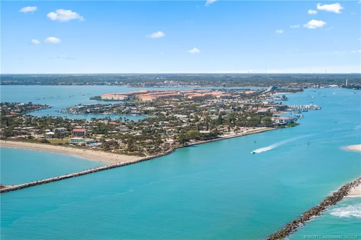 Aerial view showcases the Fort Pierce Inlet with Hutchinson Island, beaches, and waterfront communities beyond.