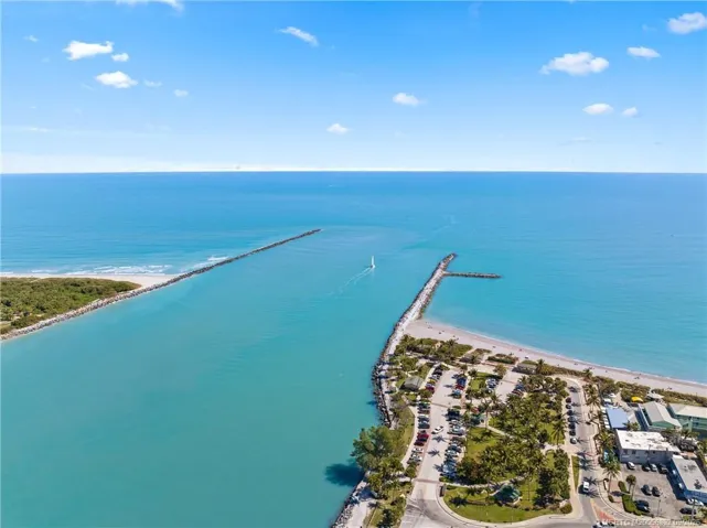 Aerial view showcases the Fort Pierce Inlet opening directly to the Atlantic Ocean and the surrounding beaches.