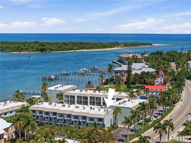 Aerial view with arrow identifying the building and highlighting its waterfront setting.
