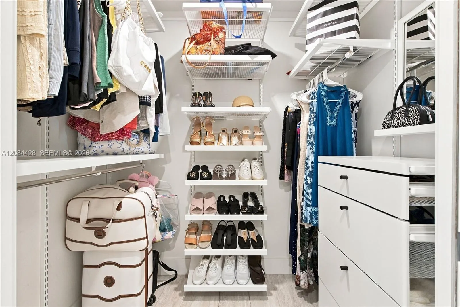 Second custom-fitted walk-in closet with extensive shelving, drawers and shoe storage. Closets will be cleared for tenant use.