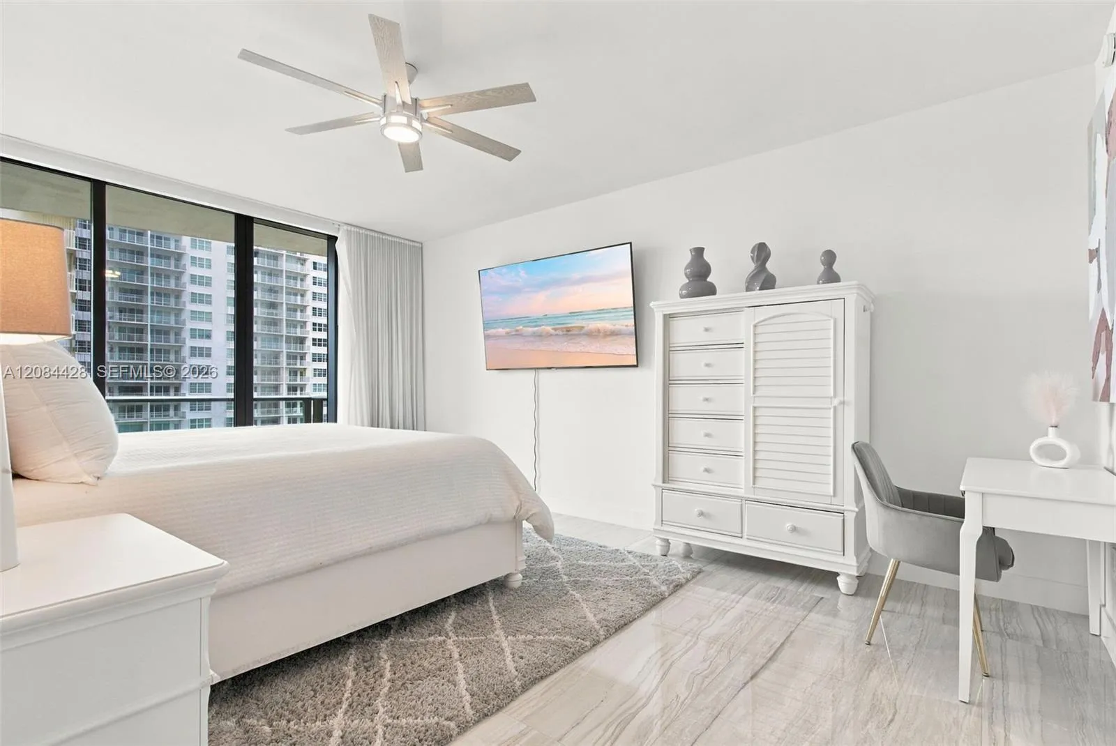 Spacious primary bedroom with an additional sitting or workspace area.