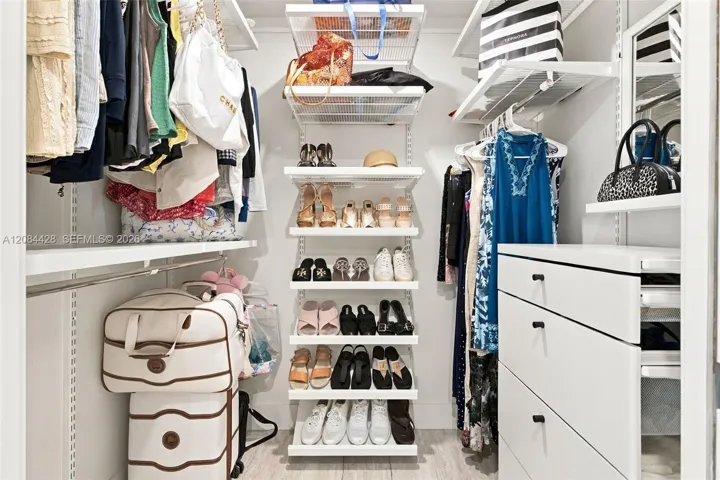 Second custom-fitted walk-in closet with extensive shelving, drawers and shoe storage. Closets will be cleared for tenant use.
