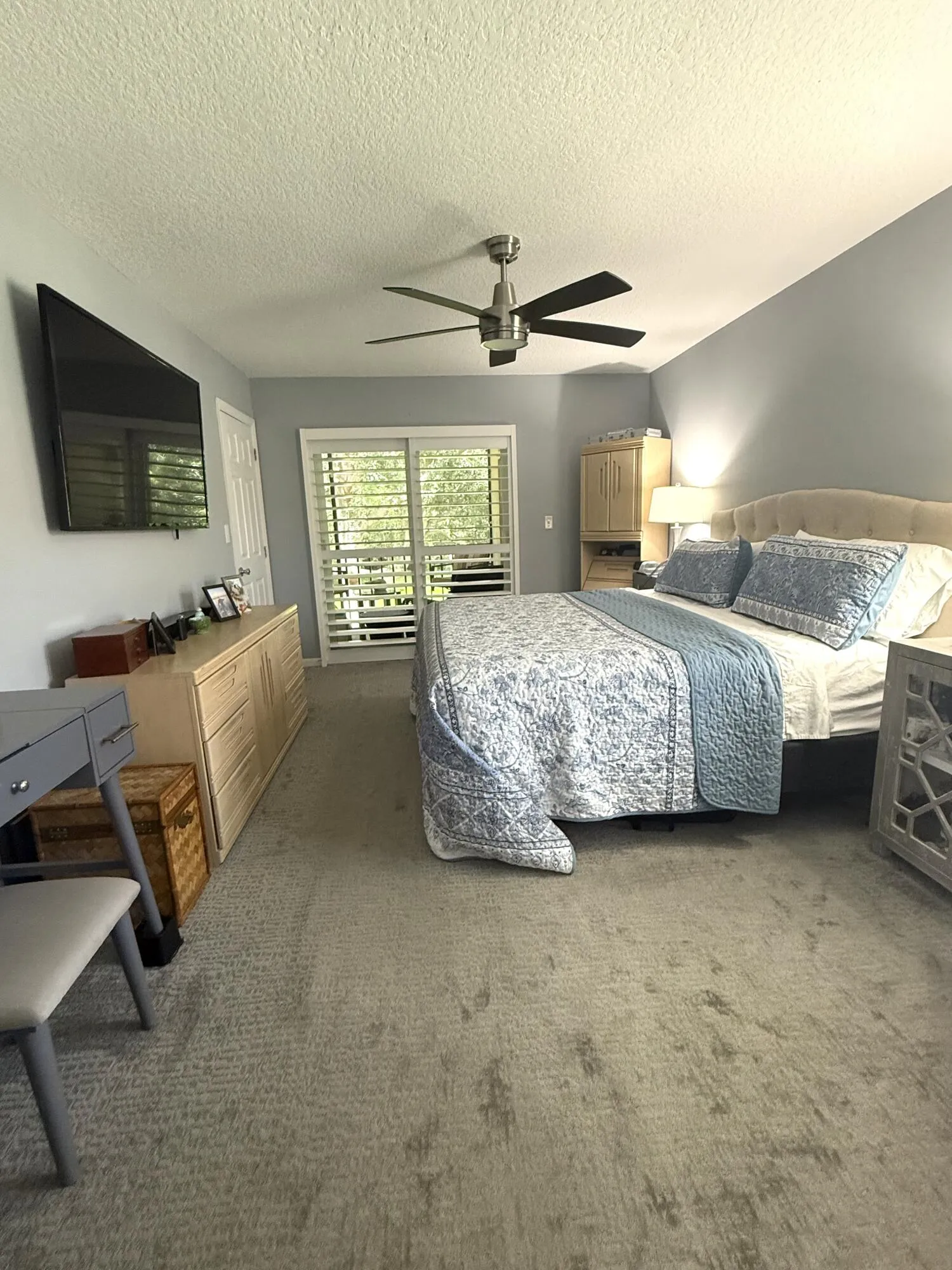 Master Bedroom impact slider, impact window both with plantation shutters