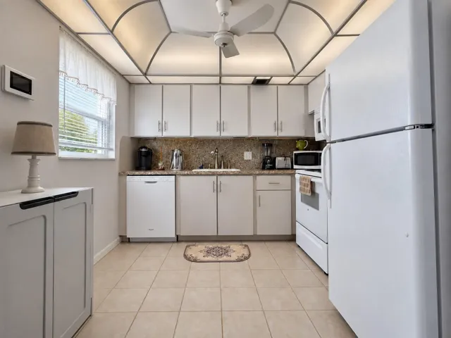 Spacious Kitchen With Updated Cabinets, Granite Look Counters, and Window for Natural Light