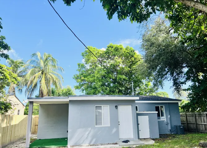 Back of house with backdoor and storage shed