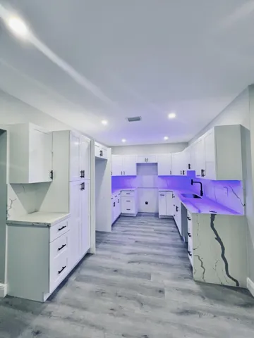 New, Modern, sleek kitchen with waterfall edge countertops