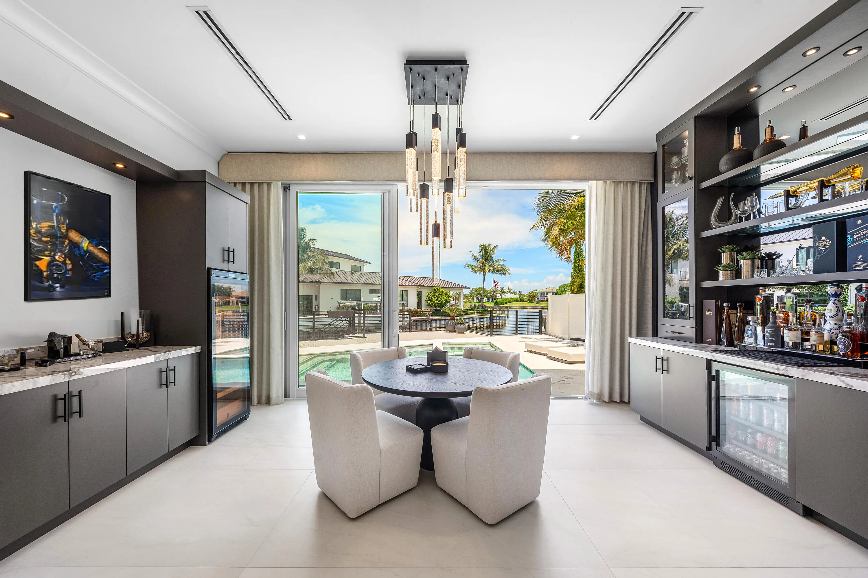Dine with a gorgeous view of the water with easy access to your custom bar and backyard