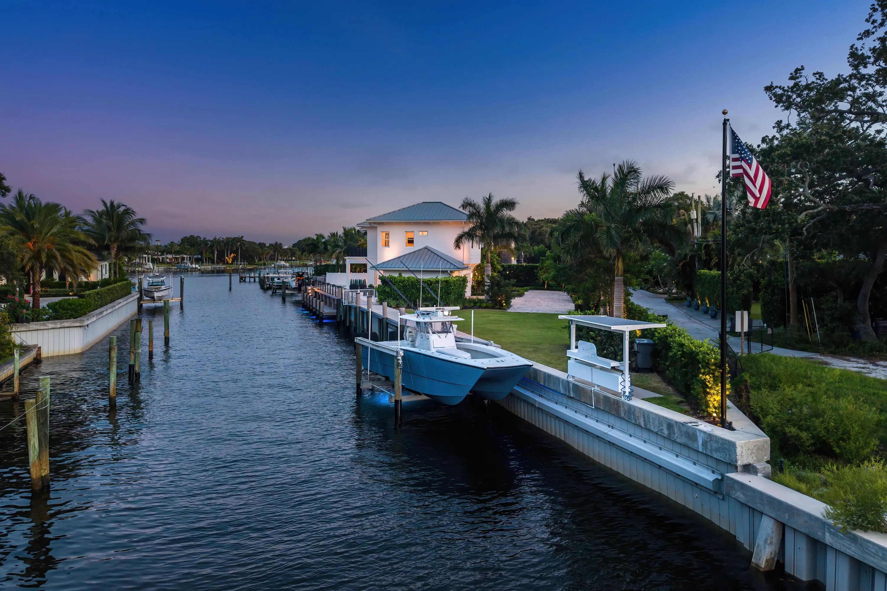 Waterfront property featuring a private boat lift, concrete seawall