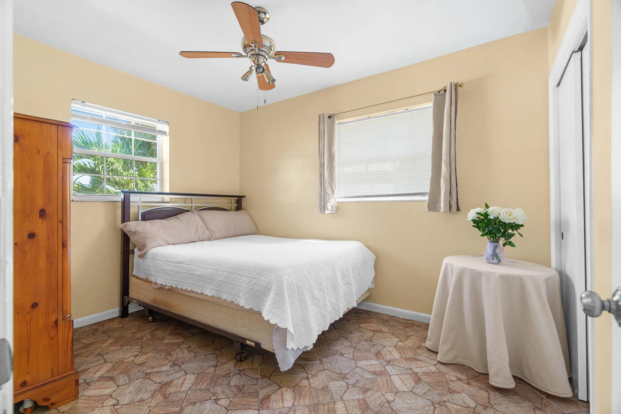 Recessed windows, ceiling fan with integrated lighting, and neutral wall tones