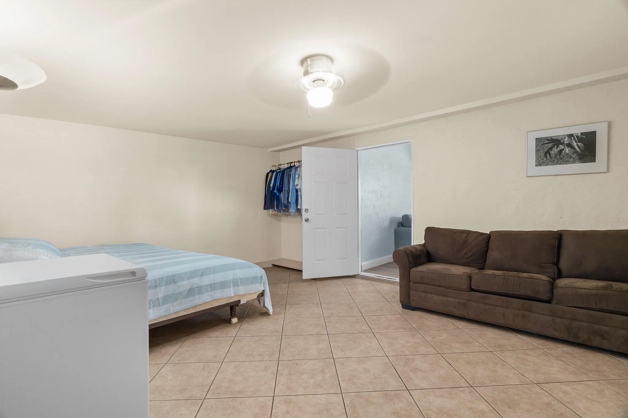 Tile flooring throughout, recessed lighting, and a solid core door
