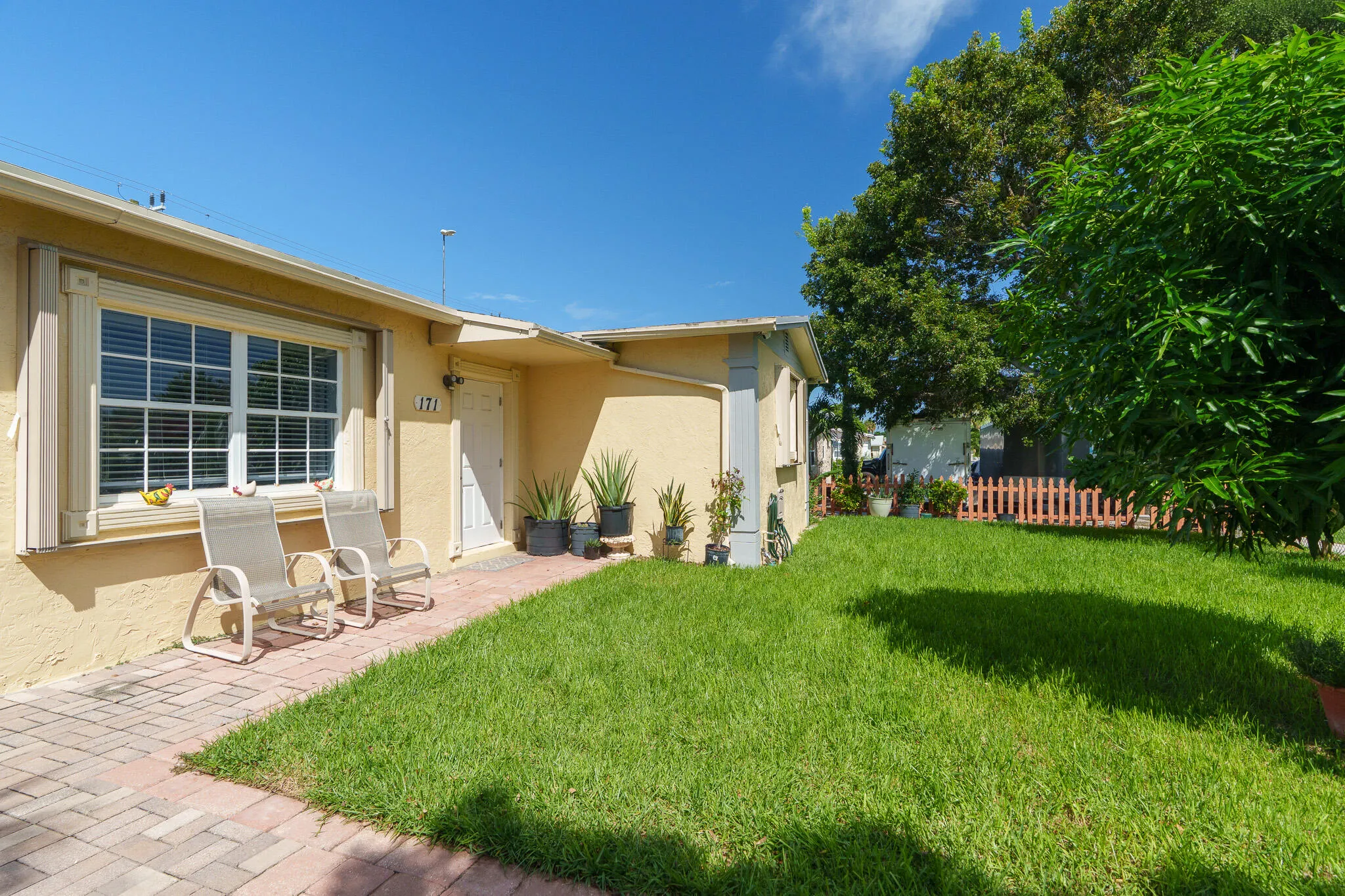 Exterior with stucco finish and a white paneled entry door