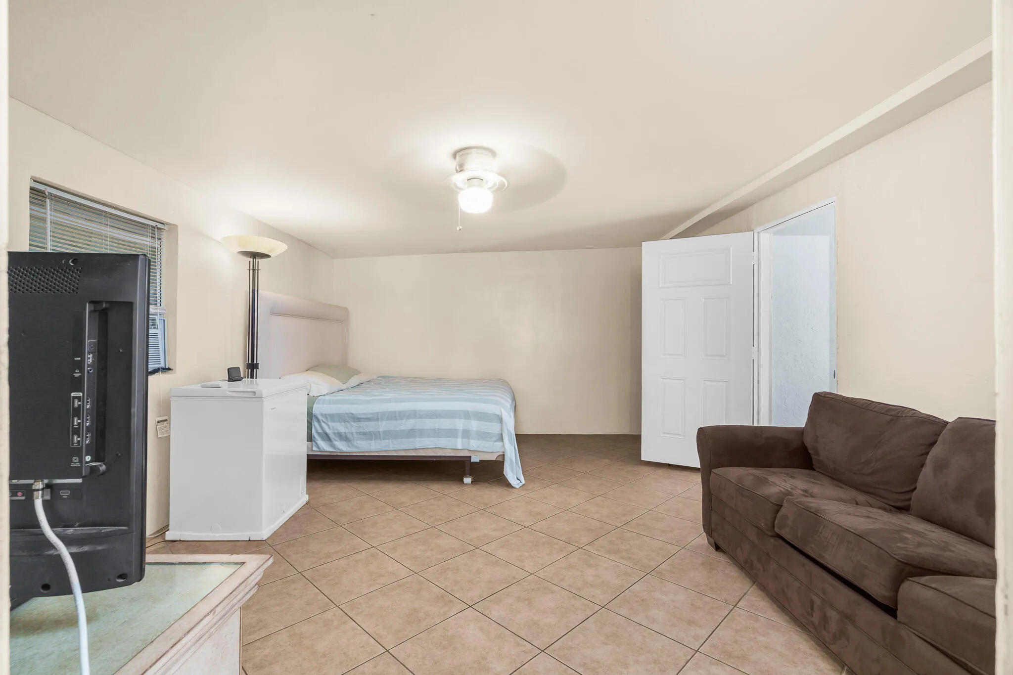 Neutral-toned ceramic tile flooring with a flush-mount ceiling light fixture