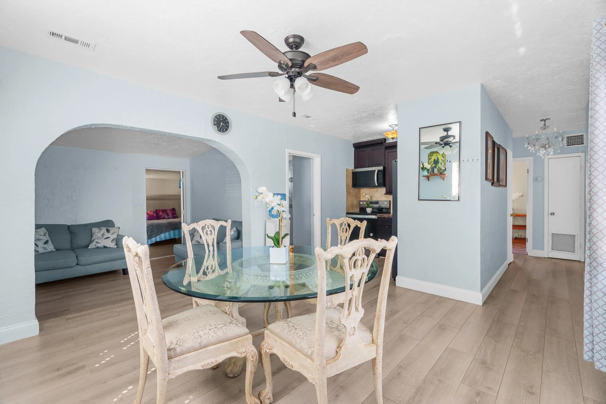 Wood-finish flooring, recessed lighting, and a ceiling fan with light kit