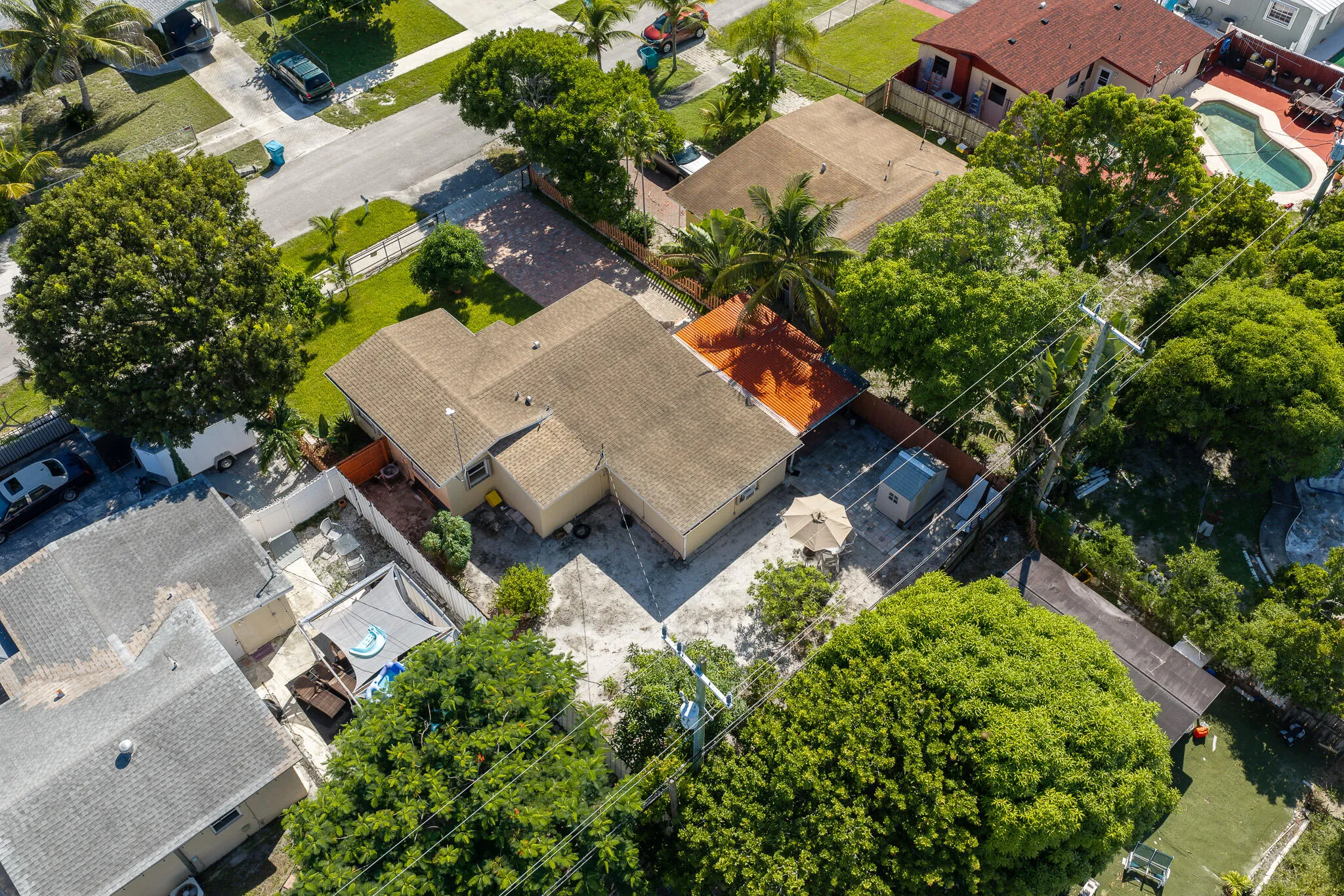 Single-story residence with a light-toned exterior and a brown shingle roof
