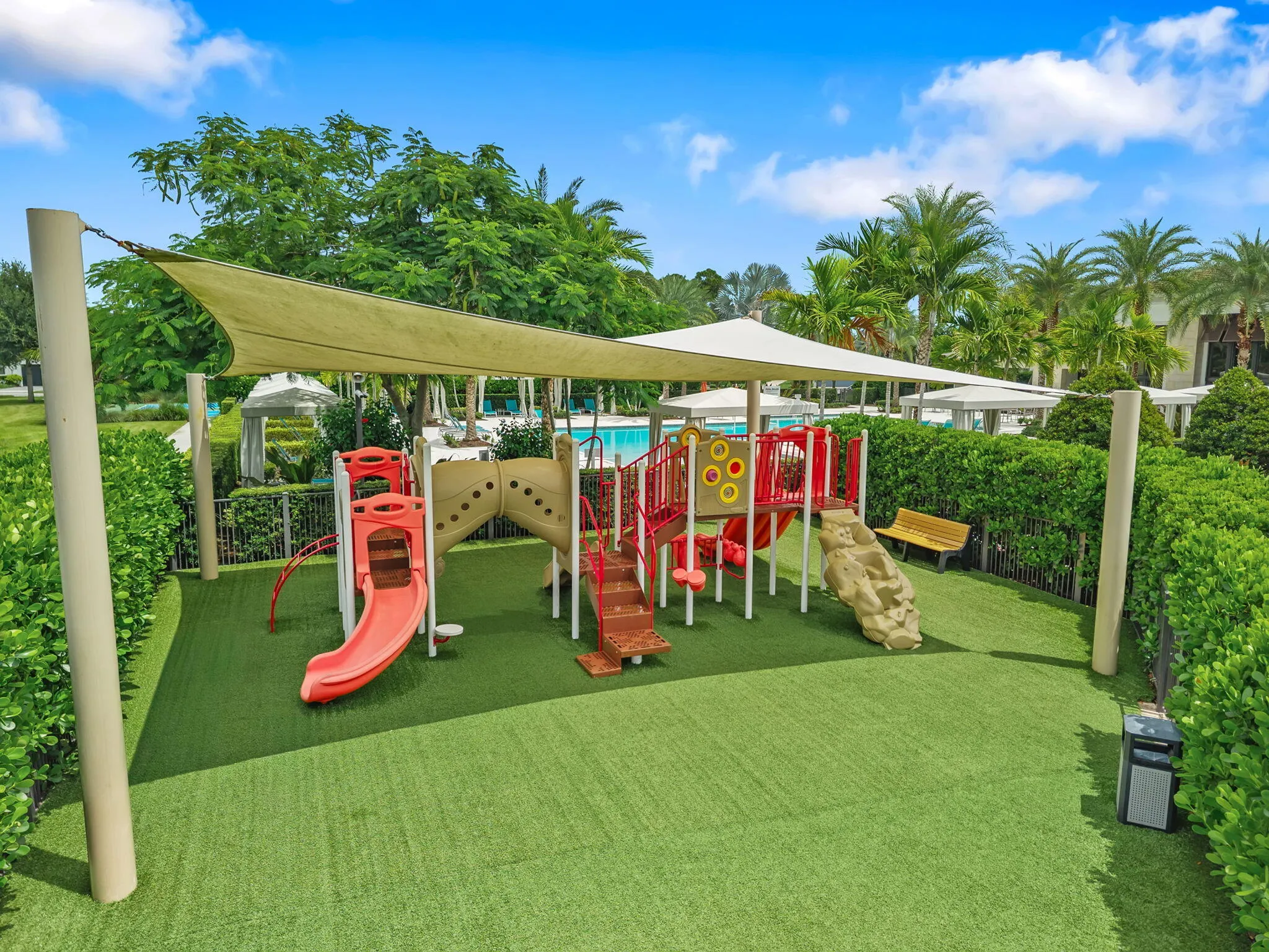 Playground featuring a multi-level structure, slides, and shaded areas