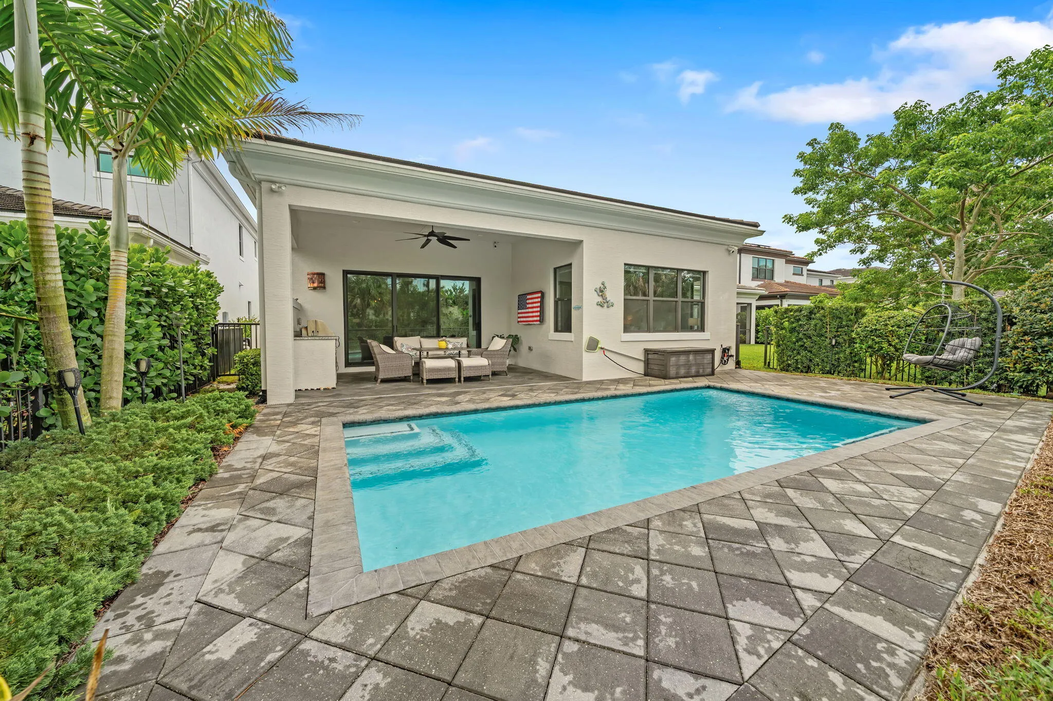 Private swimming pool with paver decking and integrated steps
