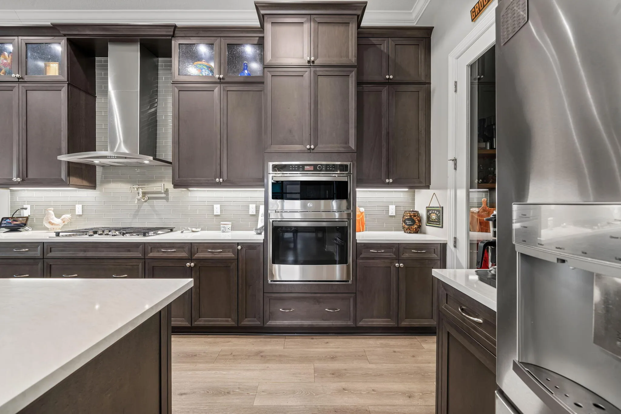 Stainless steel appliances, built-in microwave-oven combo, Quartz countertops, and dark cabinetry