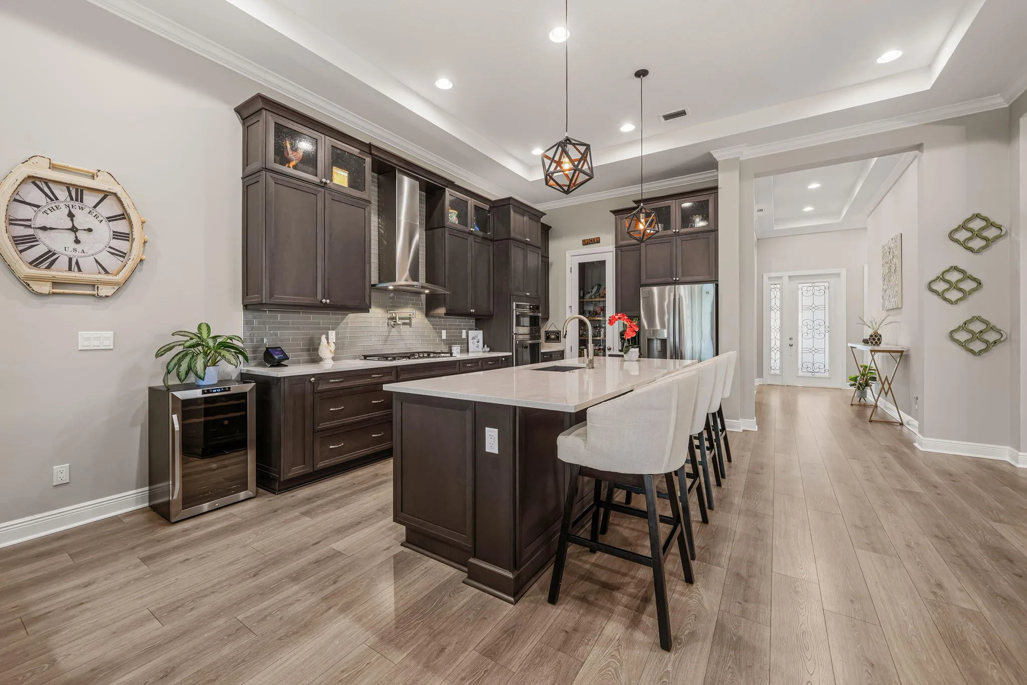 Open floor plan kitchen, Quartz countertops, glass tile backsplash, near 10ft island with large basin sink.