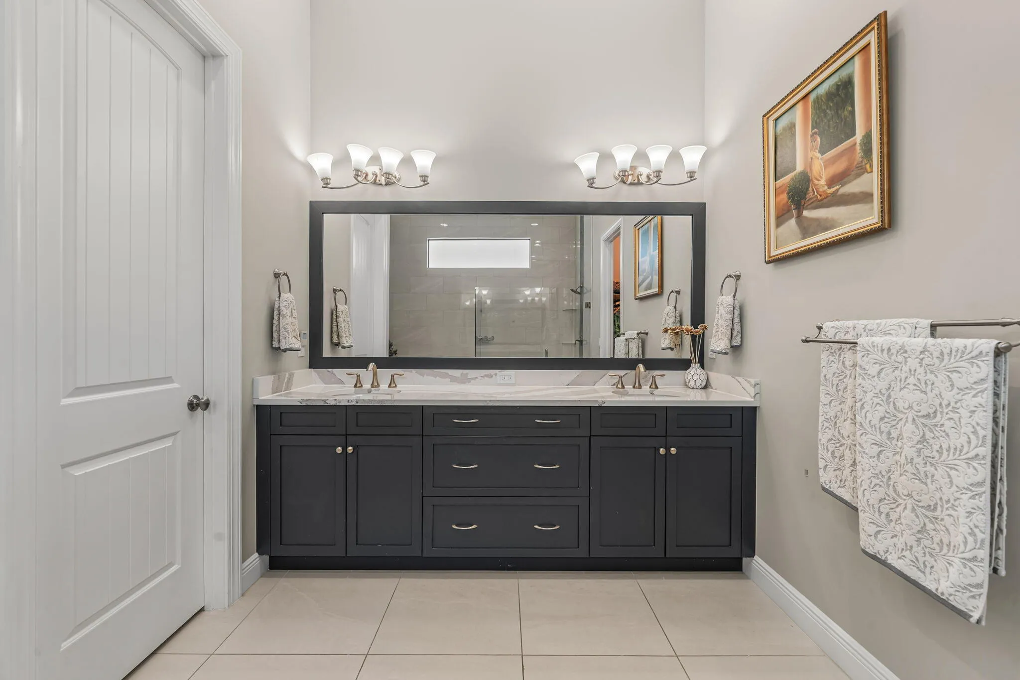 Dual vanity with dark wood cabinetry and Quartz countertops
