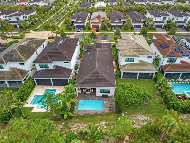 White stucco exterior with dark tile roofing