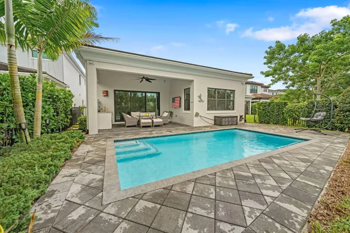 Private swimming pool with paver decking and integrated steps