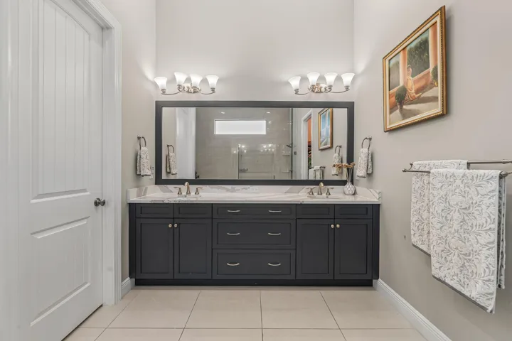 Dual vanity with dark wood cabinetry and Quartz countertops