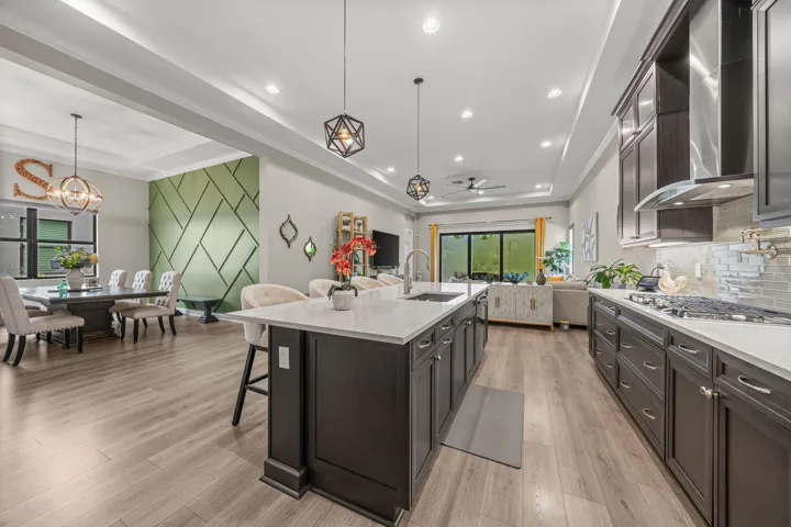 Spacious kitchen with dark wood cabinetry, Quartz countertops, and stainless steel appliances
