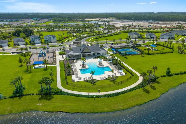 Community amenities featuring a clubhouse, swimming pool, tennis courts, and playground structures