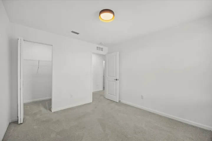 Neutral wall tones with carpeted flooring