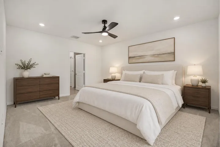 Recessed lighting, ceiling fan, neutral wall tones, and light-toned carpet flooring