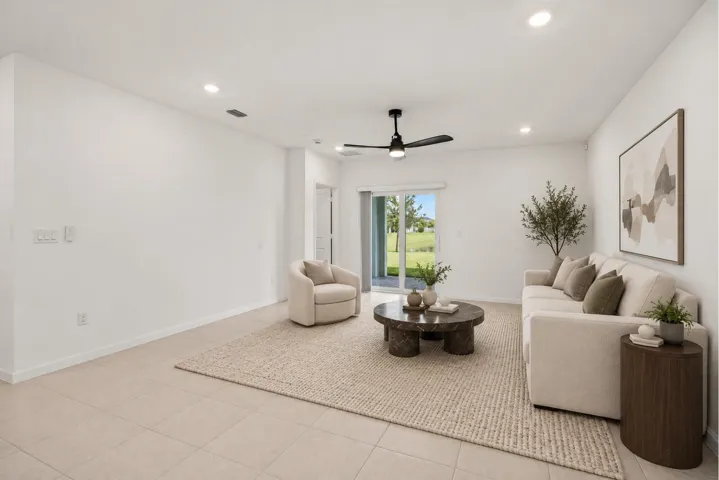 Spacious room featuring tile flooring, a ceiling fan, recessed lighting, and sliding glass doors to the exterior