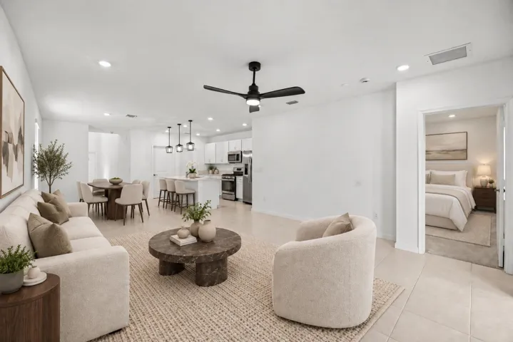 Open concept living area with tiled flooring, recessed lighting, ceiling fan, white cabinetry, and stainless steel appliances