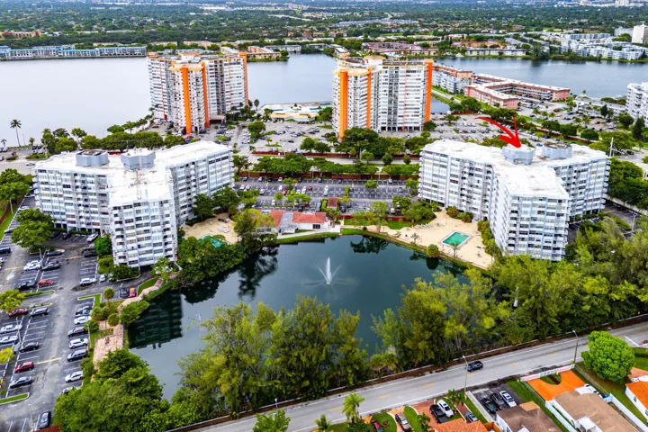 Multi-story residential buildings with water features and surrounding landscaping