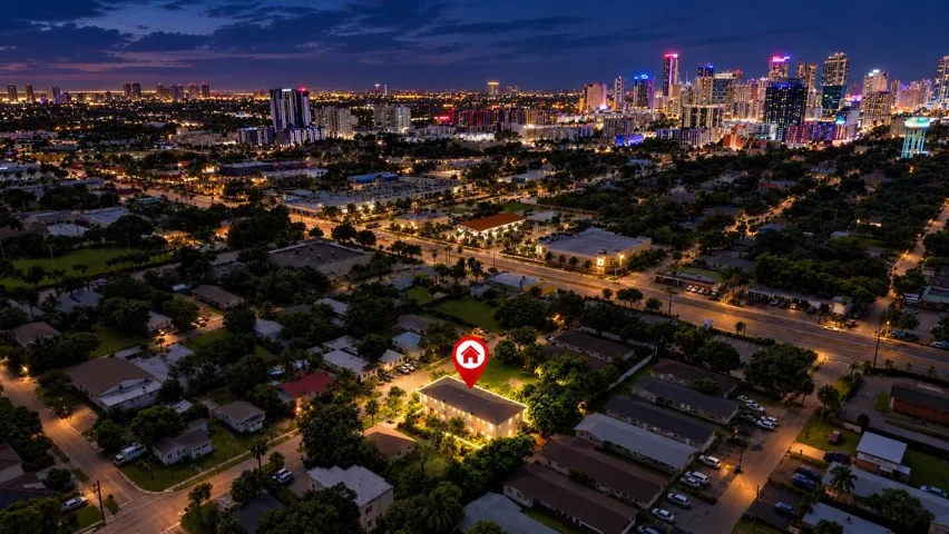 Aerial perspective of a neighborhood with diverse residential structures and mature landscaping