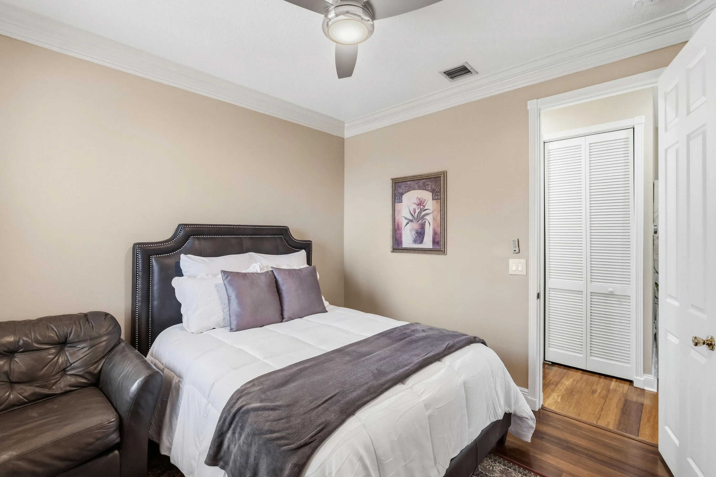 Another view of the bedroom showcasing its comfortable layout and storage.