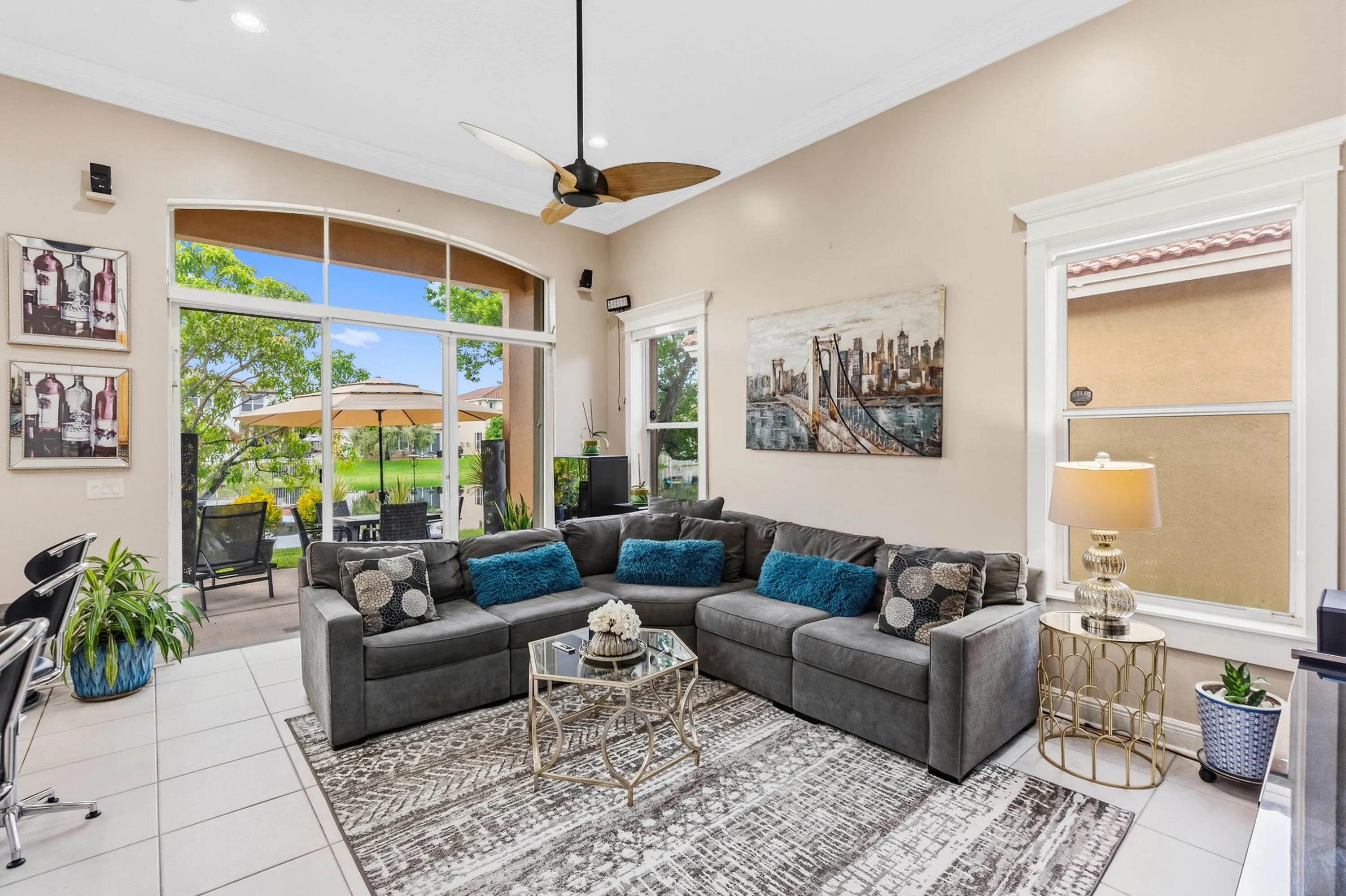 Volume ceilings and expansive windows fill the family room with natural light and lake views.