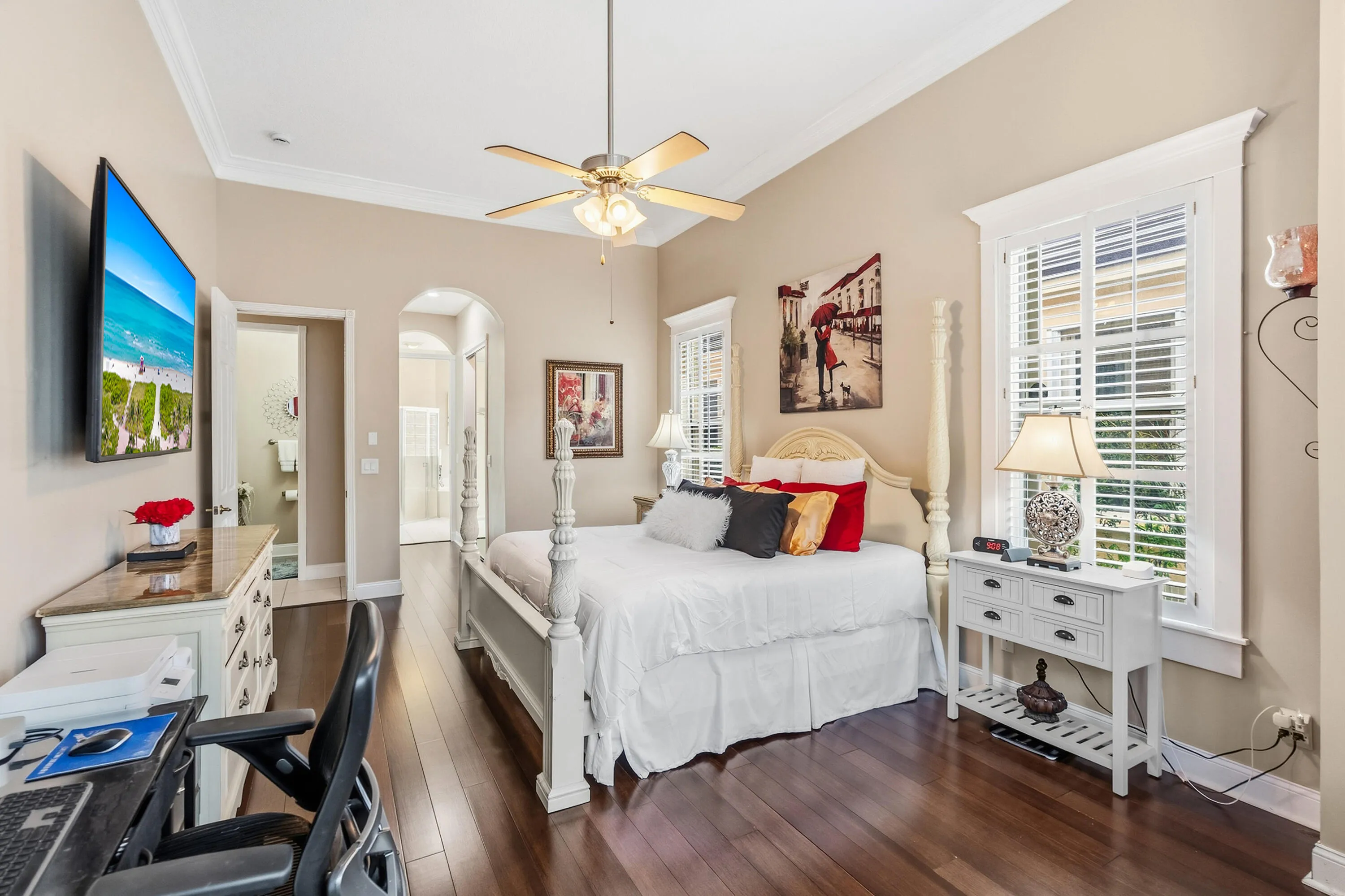 Another view of the primary suite showcasing its spacious layout and direct access to the ensuite bathroom and walk-in closet.