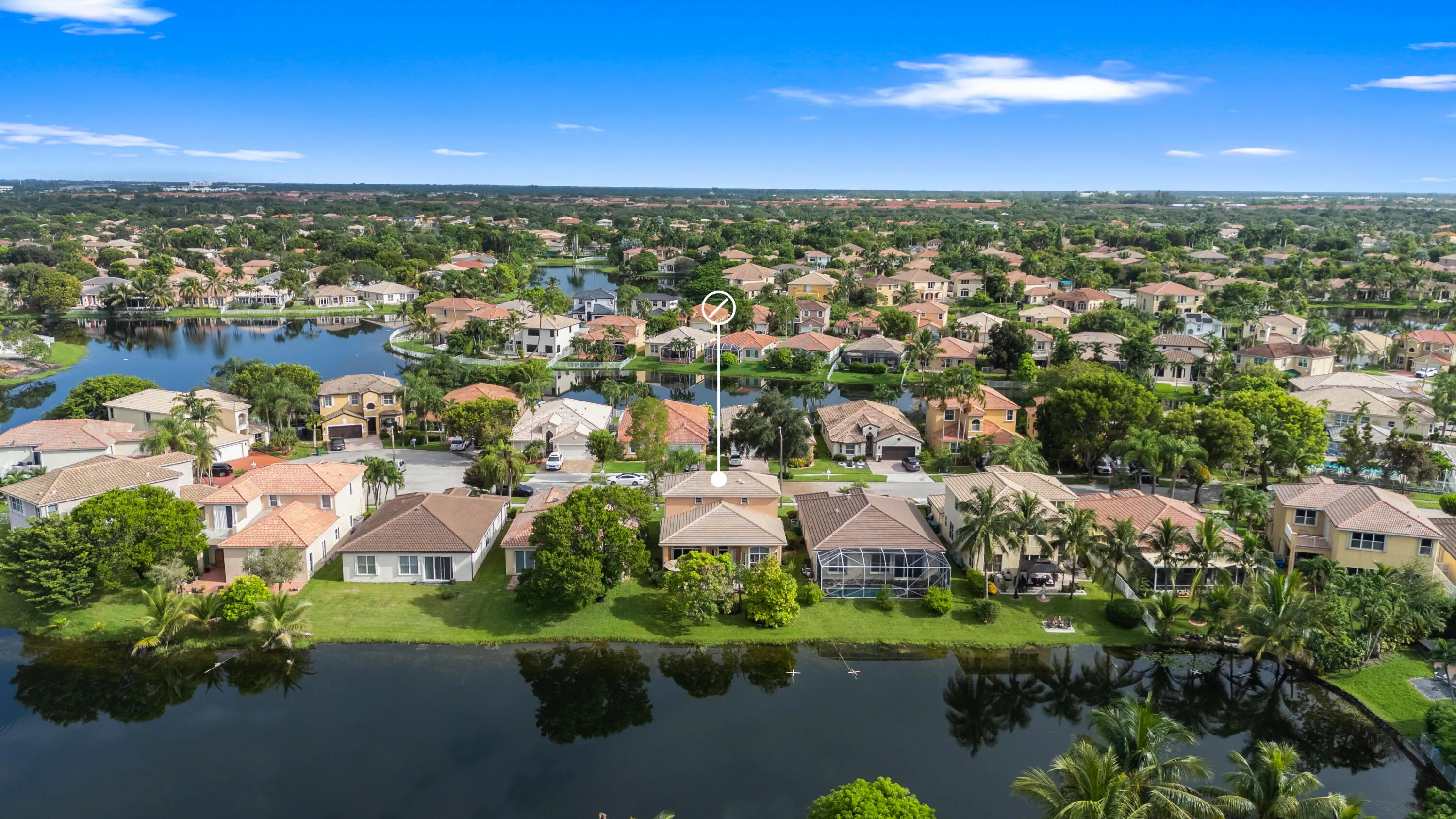 Elevated view highlighting the home’s location among the interconnected lakes and surrounding residences of Monarch Lakes.