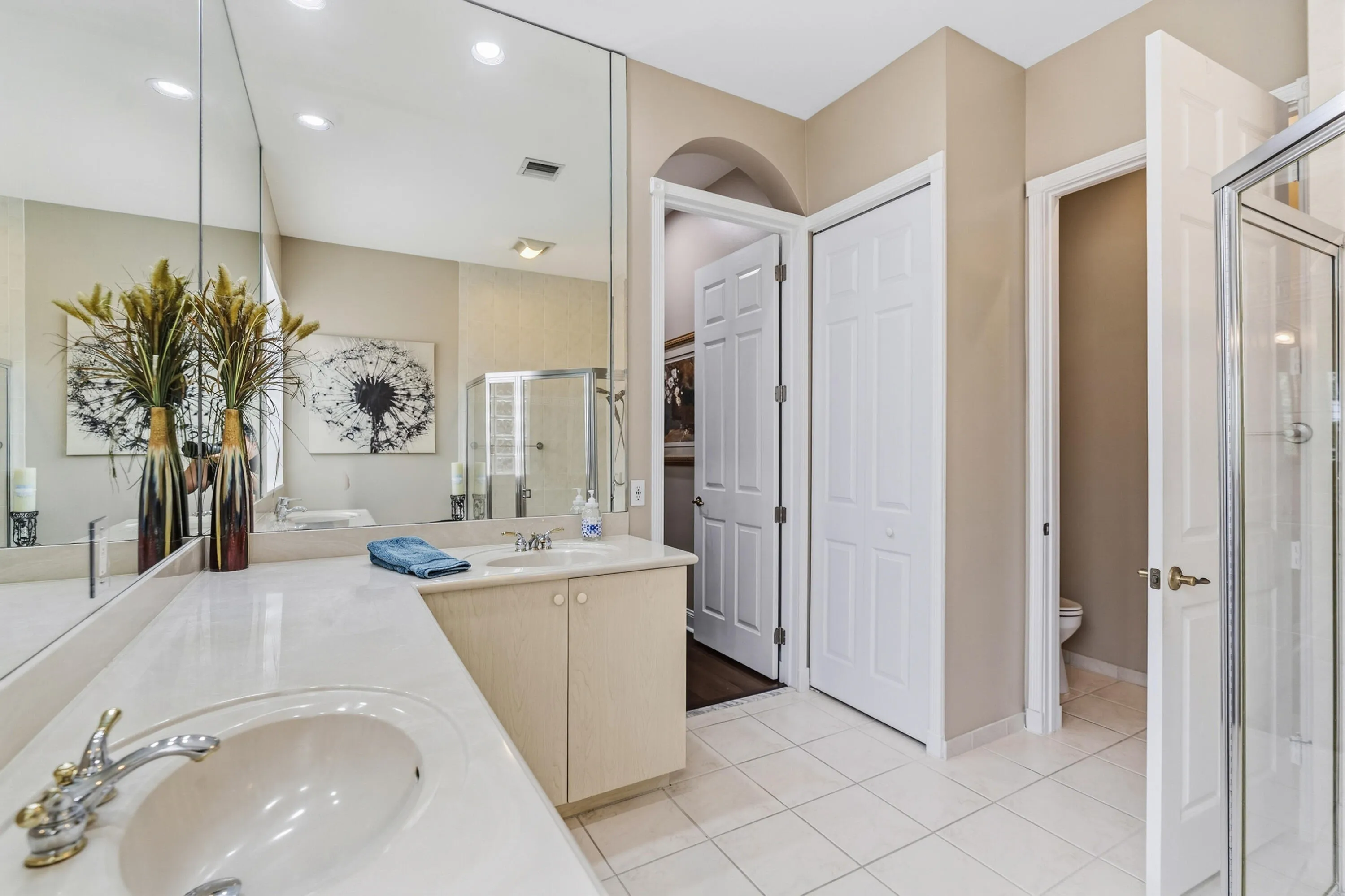 Extended vanity and generous counter space provide functionality and storage in the primary bath.