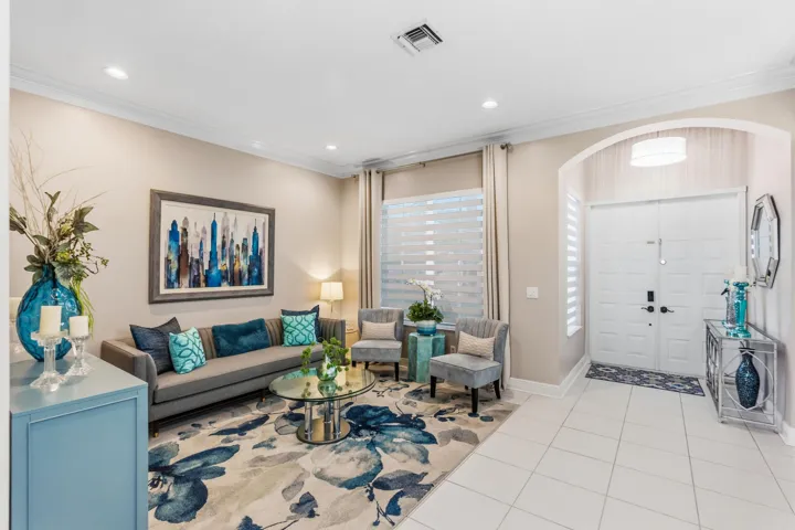 Bright living room offers a comfortable gathering space just off the home’s entry.