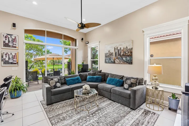 Volume ceilings and expansive windows fill the family room with natural light and lake views.