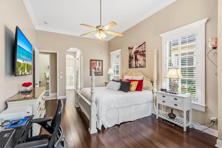 Another view of the primary suite showcasing its spacious layout and direct access to the ensuite bathroom and walk-in closet.