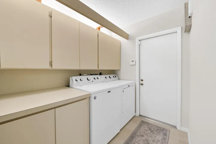 Built-in cabinetry with ample storage, extended countertop space, and tile flooring