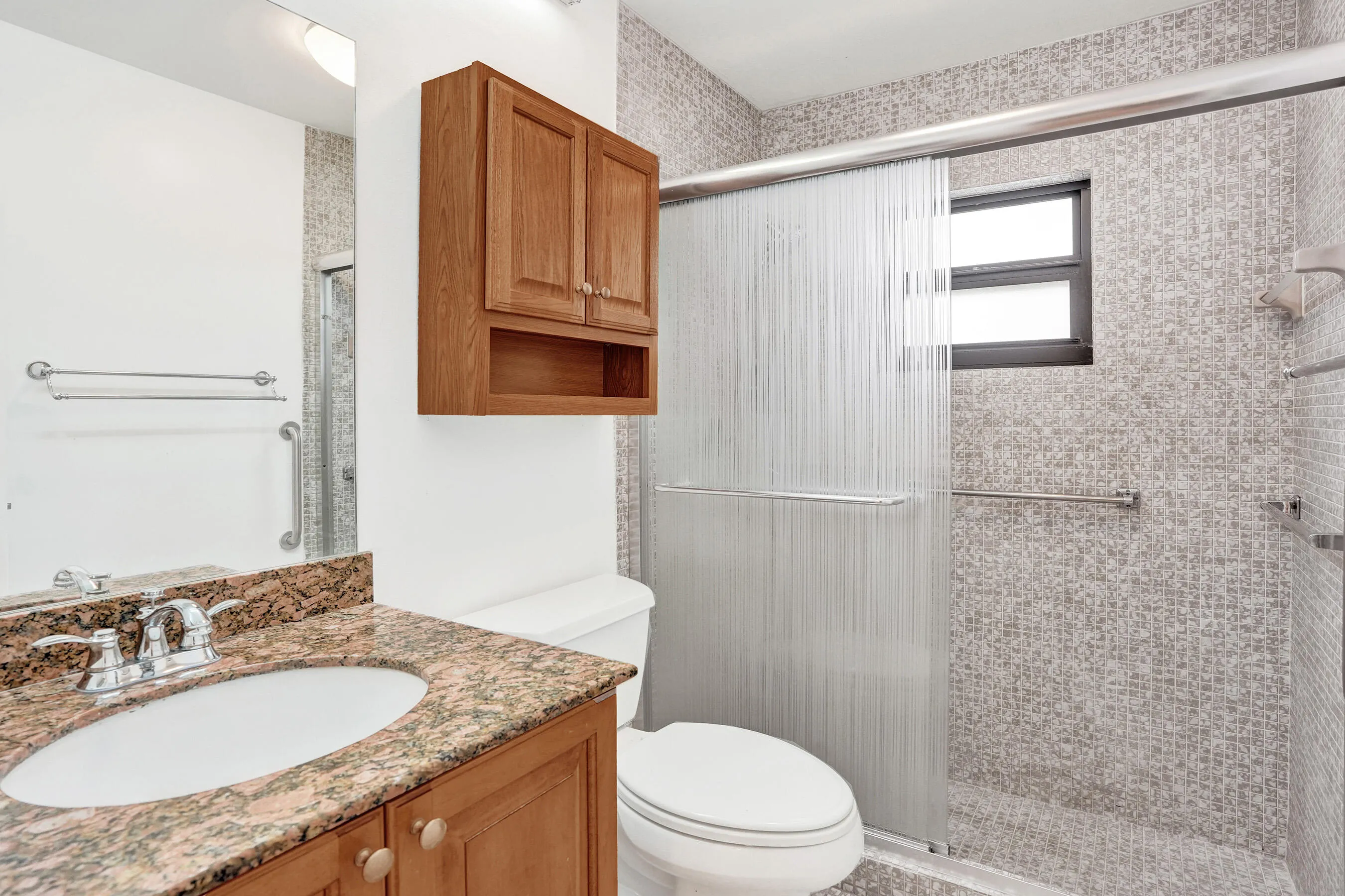 Vanity with a granite countertop and undermount sink