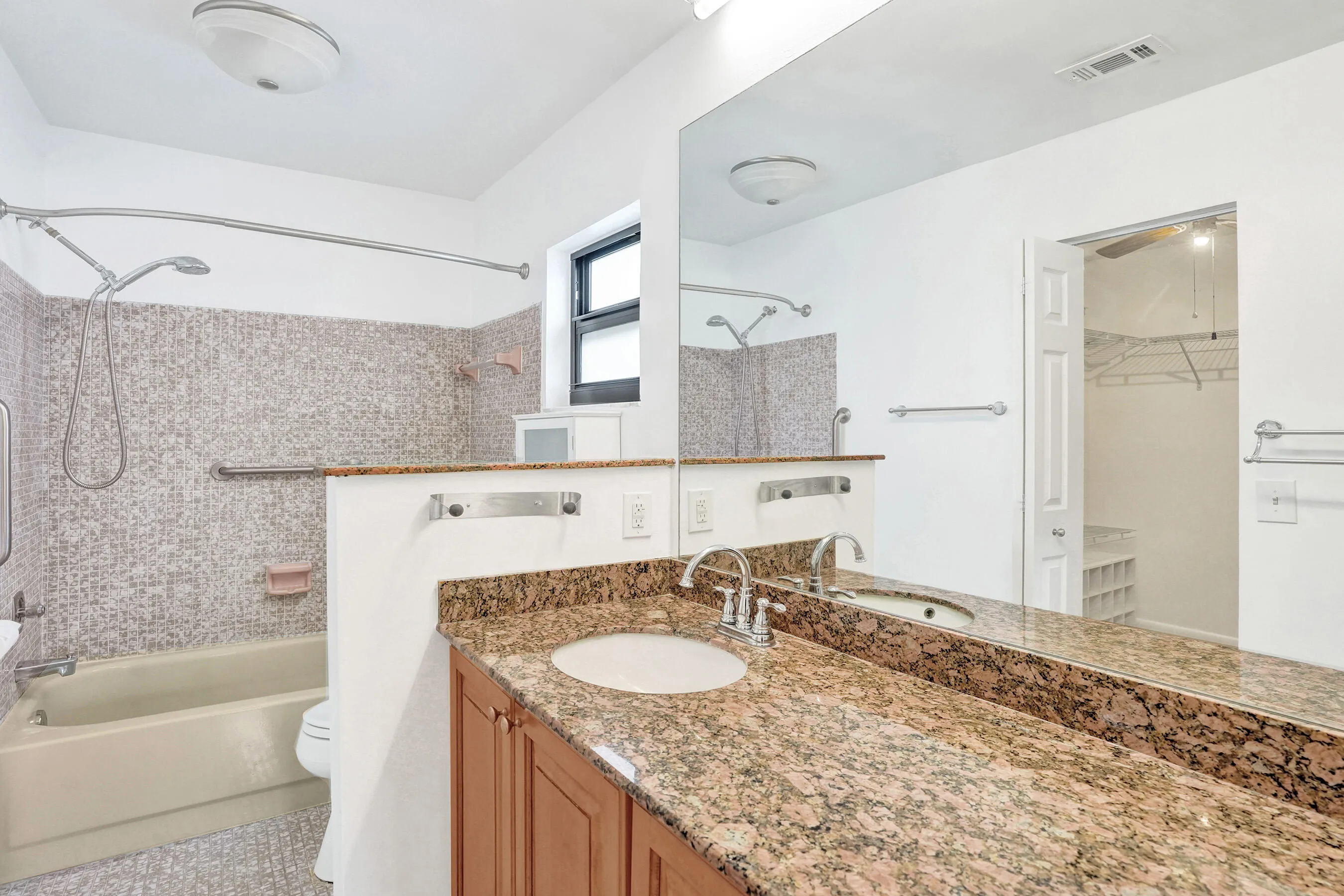 Wood-finish cabinetry with a granite-style countertop and integrated sink
