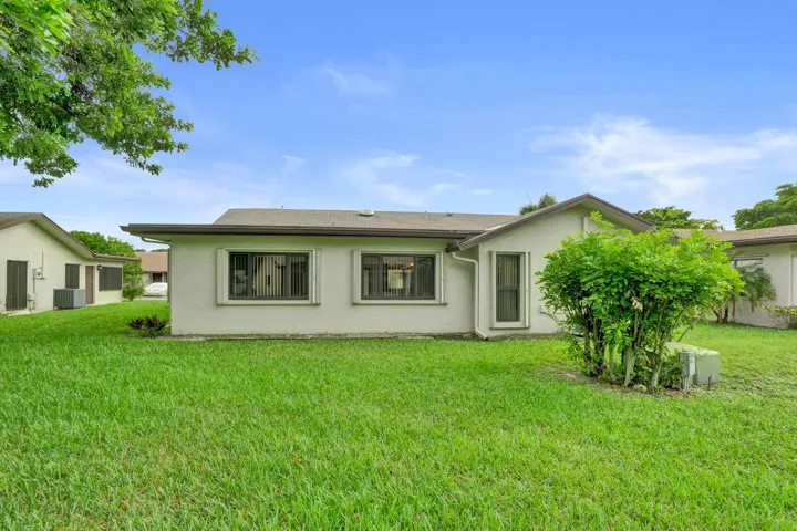 Expansive green lawn surrounds the property