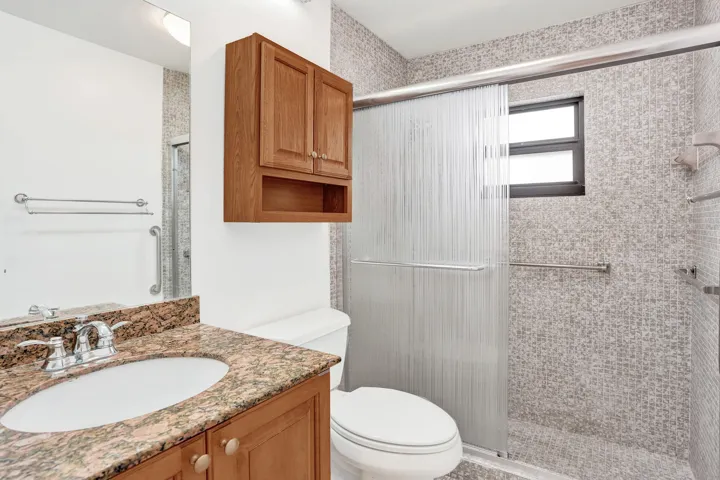 Vanity with a granite countertop and undermount sink